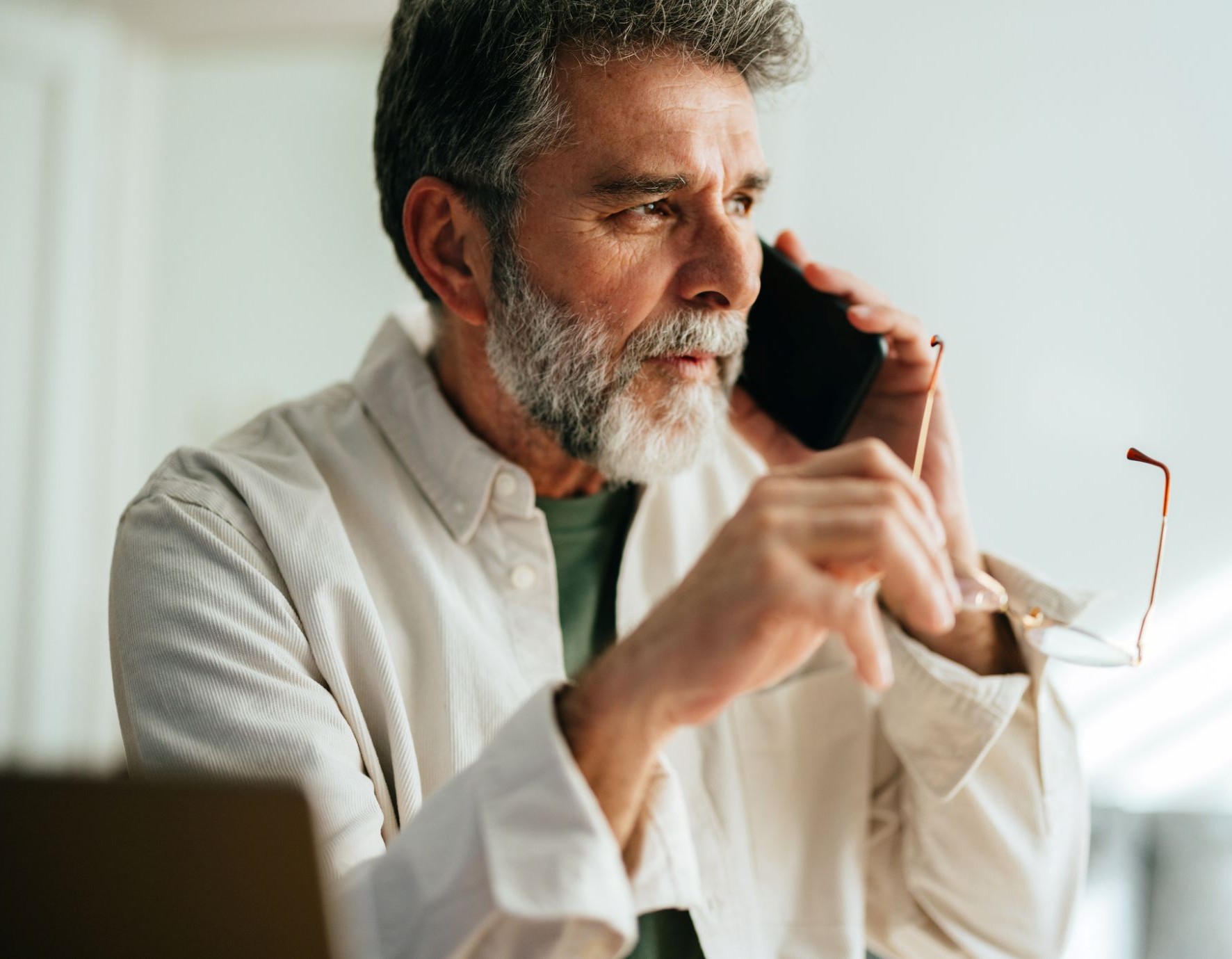 older man talking on his phone