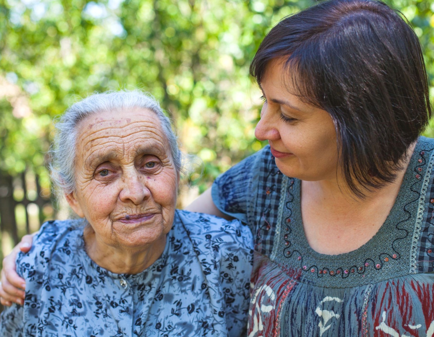 Young woman and older woman standing together