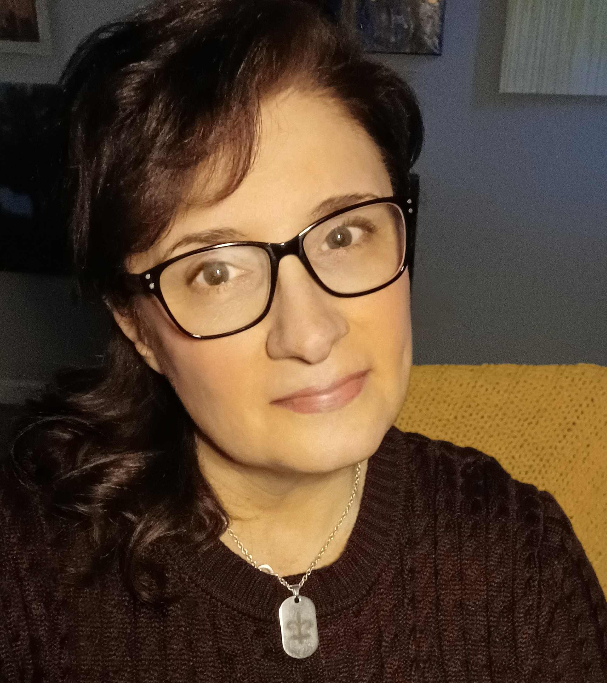 Jill Jacobs is a woman with brown hair that she is wearing tied back. She is wearing dark colored glasses and a brown sweater.