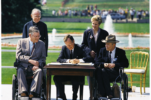 President George H.W. Bush signs the Americans with Disabilities Act.