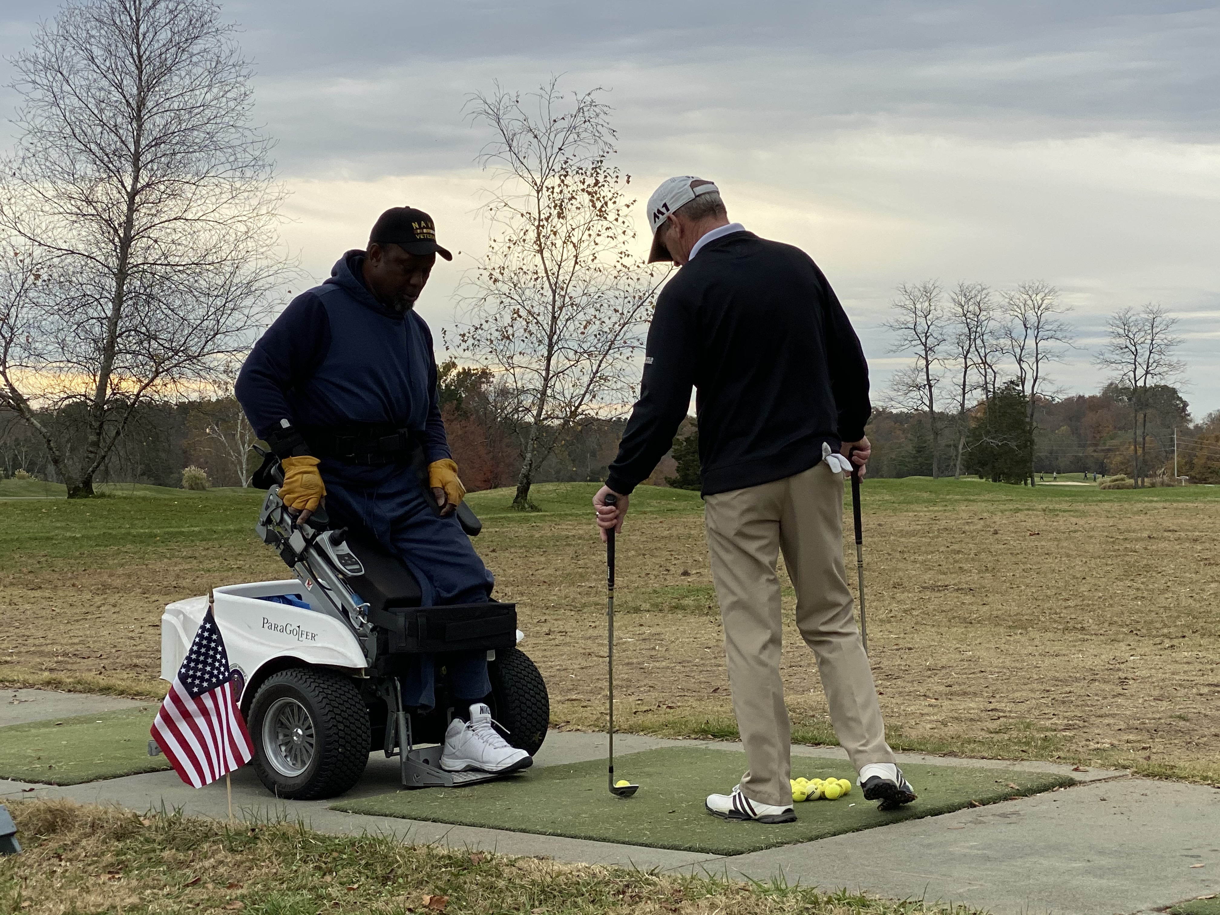 A participant tries golfing with an adaptive wheelchair