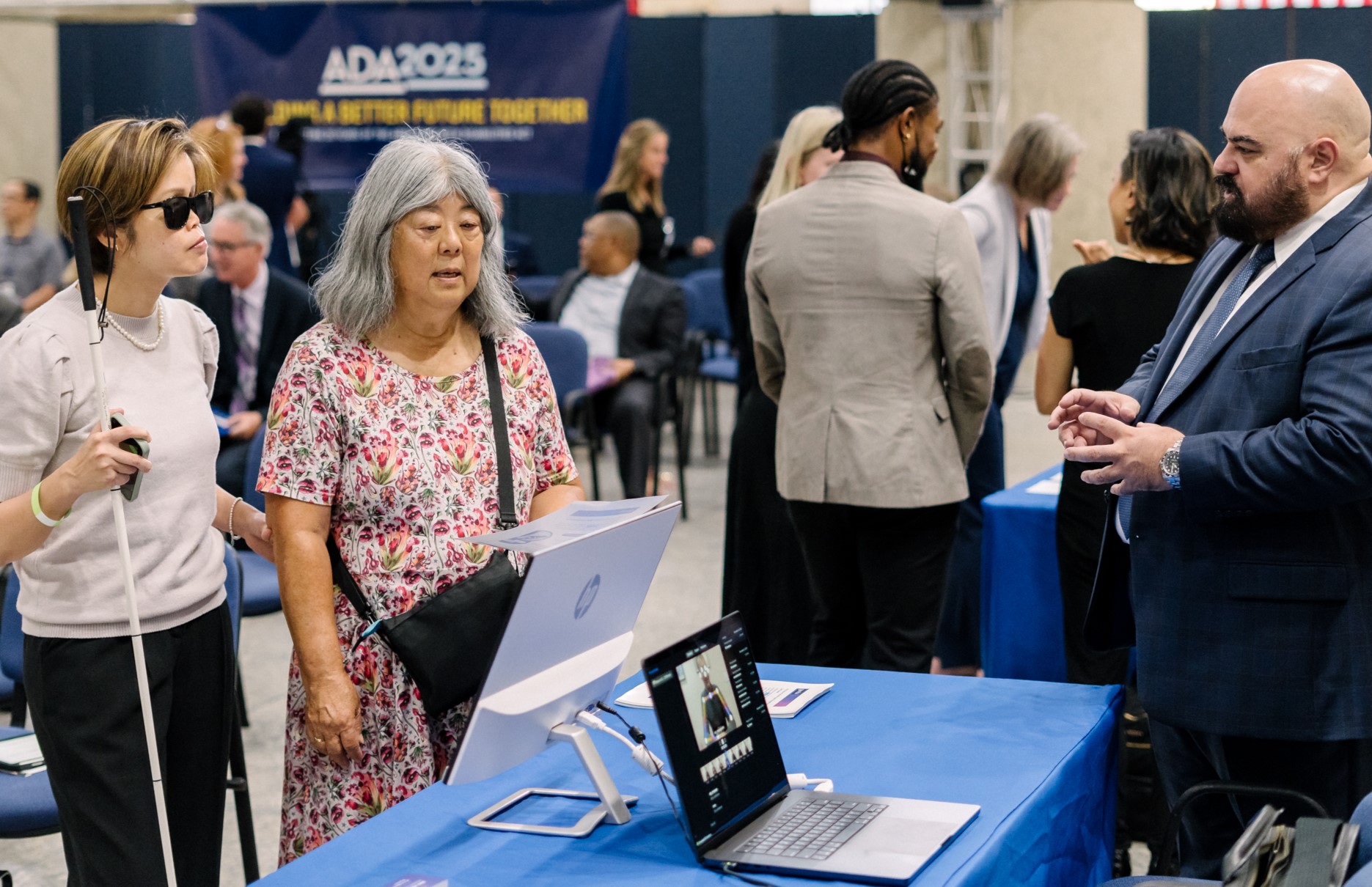 Three attendees chat at the ADA 35th Anniversary event