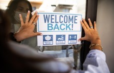 Welcome back sign with COVID precautions